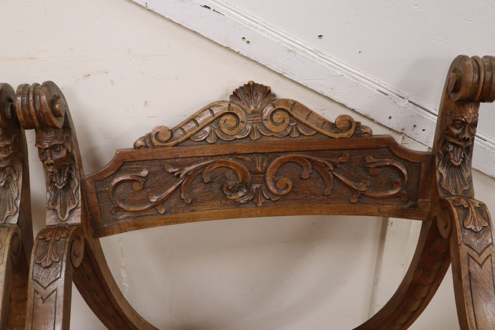 A pair of Italian carved walnut Savonarola type armchairs